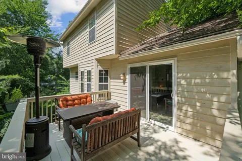 a backyard of a house with barbeque oven and outdoor seating