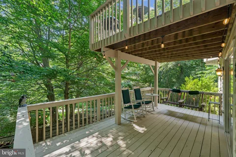 a view of balcony with chairs and wooden fence