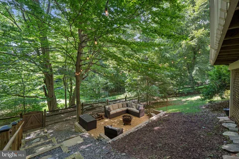a view of backyard with outdoor seating and green space