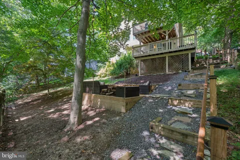 a view of a house with backyard stove and sitting area