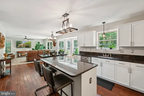 a kitchen with sink cabinets and wooden floor