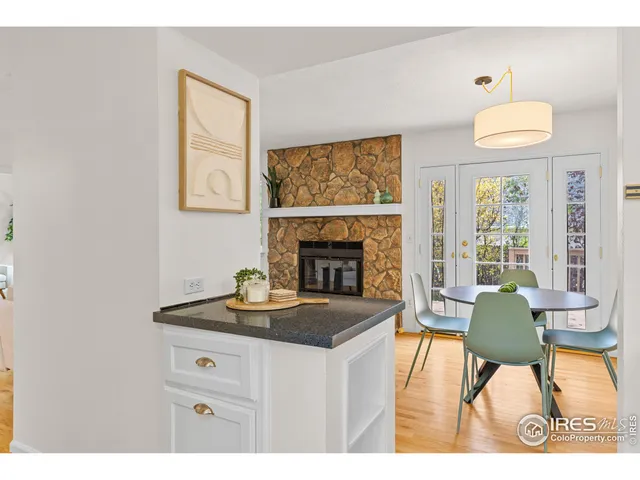 a living room with furniture a fireplace and a large mirror