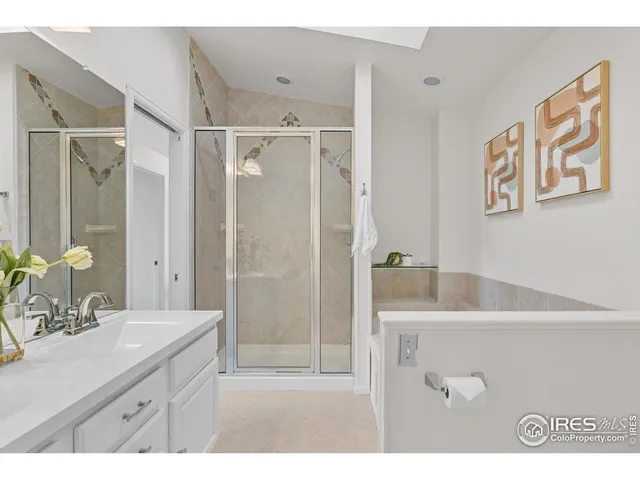 a bathroom with a tub a sink and mirror