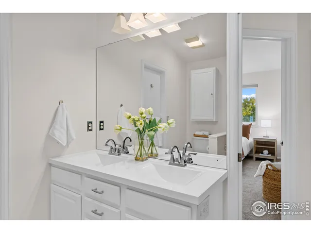 a bathroom with a sink vanity and a mirror
