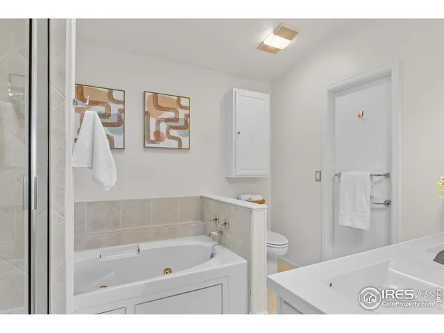 a bathroom with a tub a sink and a shower