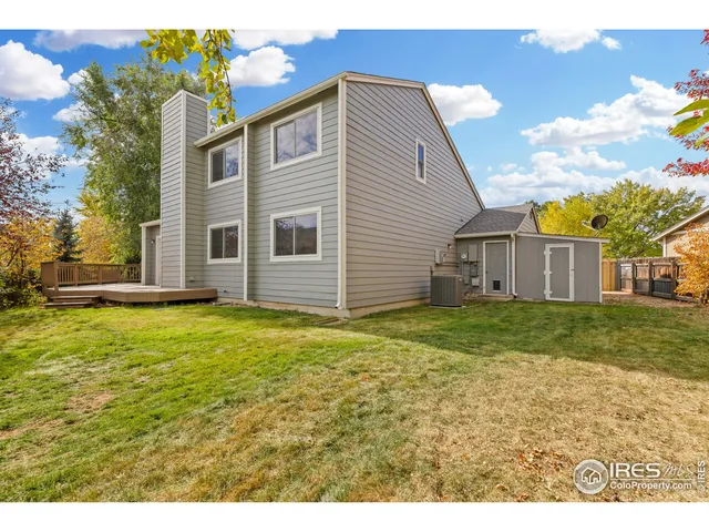 a view of a backyard with chairs