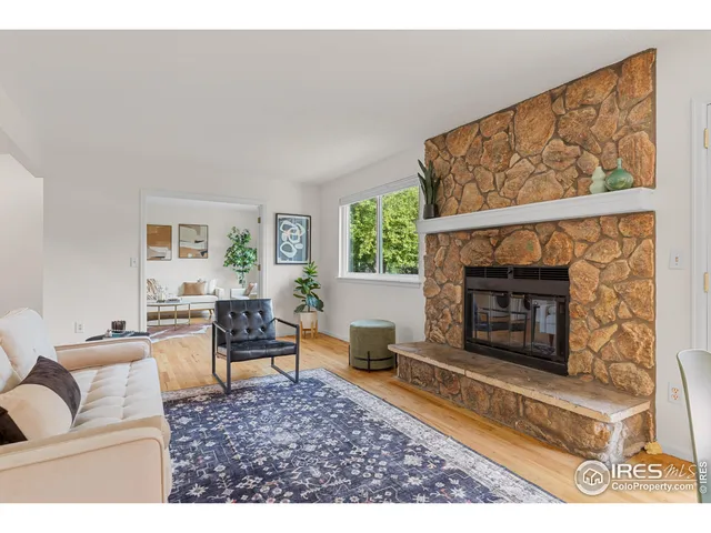 a living room with furniture a window and a fireplace