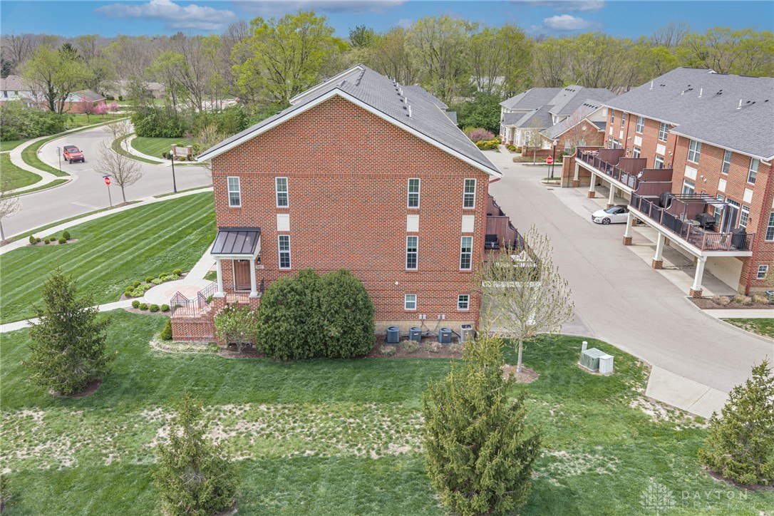 407 Brownstone Row Springboro, OH 45066 - Photo 49 of 54 This brick townhome offers a classic facade and inviting entryway in a vibrant community.