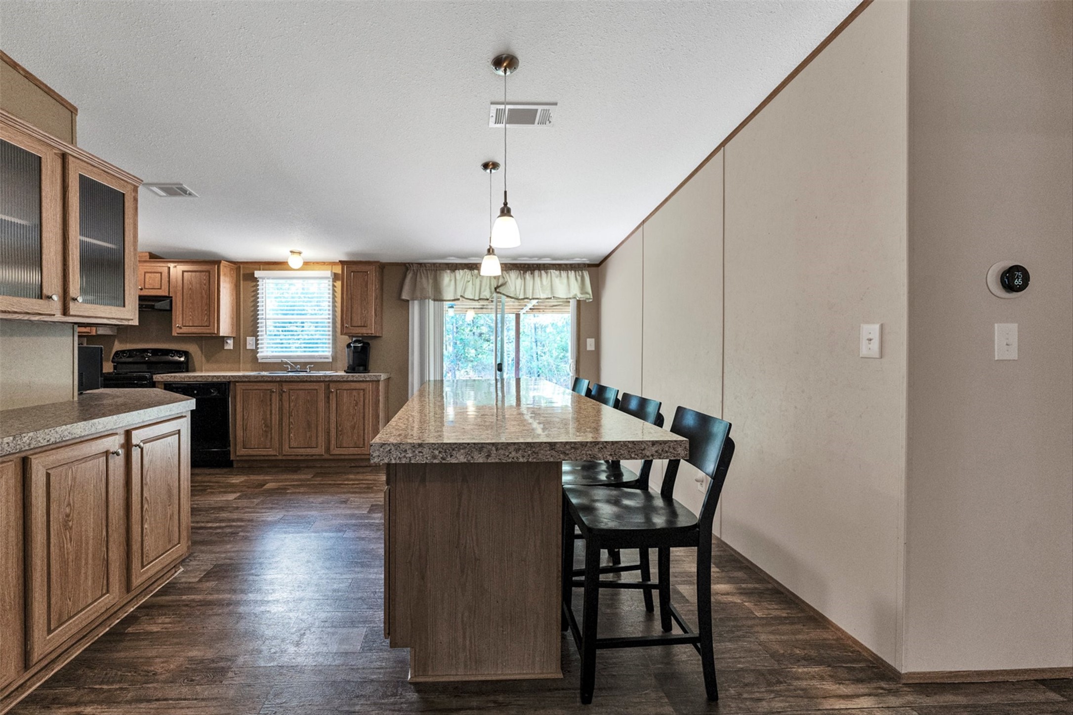 50 Fm 3179 Road Huntsville, TX 77320 - Photo 12 of 45 Spacious island bar creates the perfect connection between the living and dining spaces.