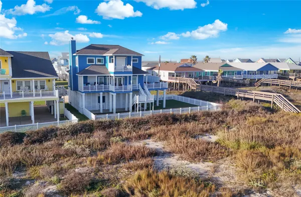 a view of a house with a yard and balcony