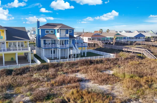 a view of a house with a yard and balcony