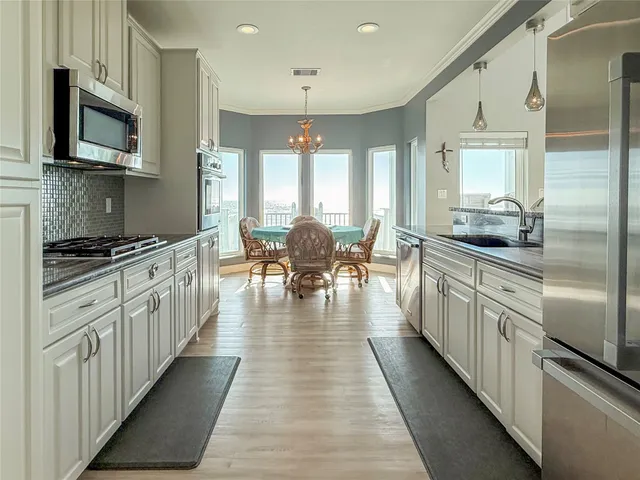 a kitchen with stainless steel appliances kitchen island granite countertop lots of counter top space and cabinets