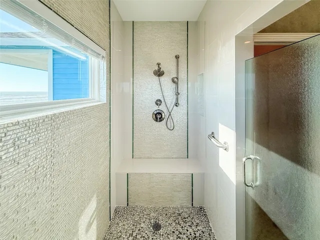 a bathroom with a granite countertop shower