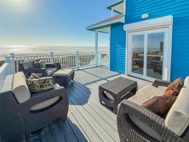 a bedroom with furniture and a balcony