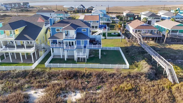 an aerial view of residential houses with yard and swimming pool