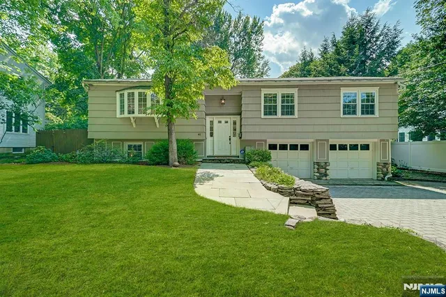 a view of a chair and table in backyard of the house