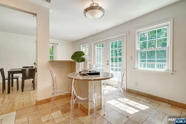 a view of a dining room with furniture and chandelier