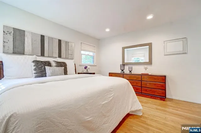 a bedroom with a bed and a dresser