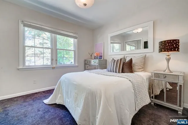 a bedroom with bed and a window