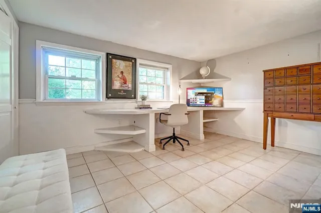 a workspace with wooden floor and a window