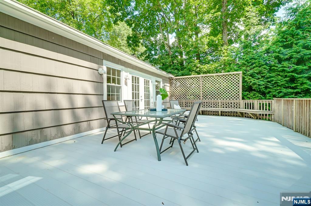 41 Demarest Avenue Demarest, NJ 07627 - Photo 24 of 28 a view of a chairs and table in the back yard of the house