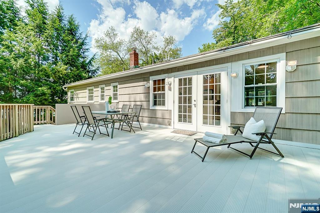 41 Demarest Avenue Demarest, NJ 07627 - Photo 25 of 28 a view of a patio with table and chairs and floor to ceiling window