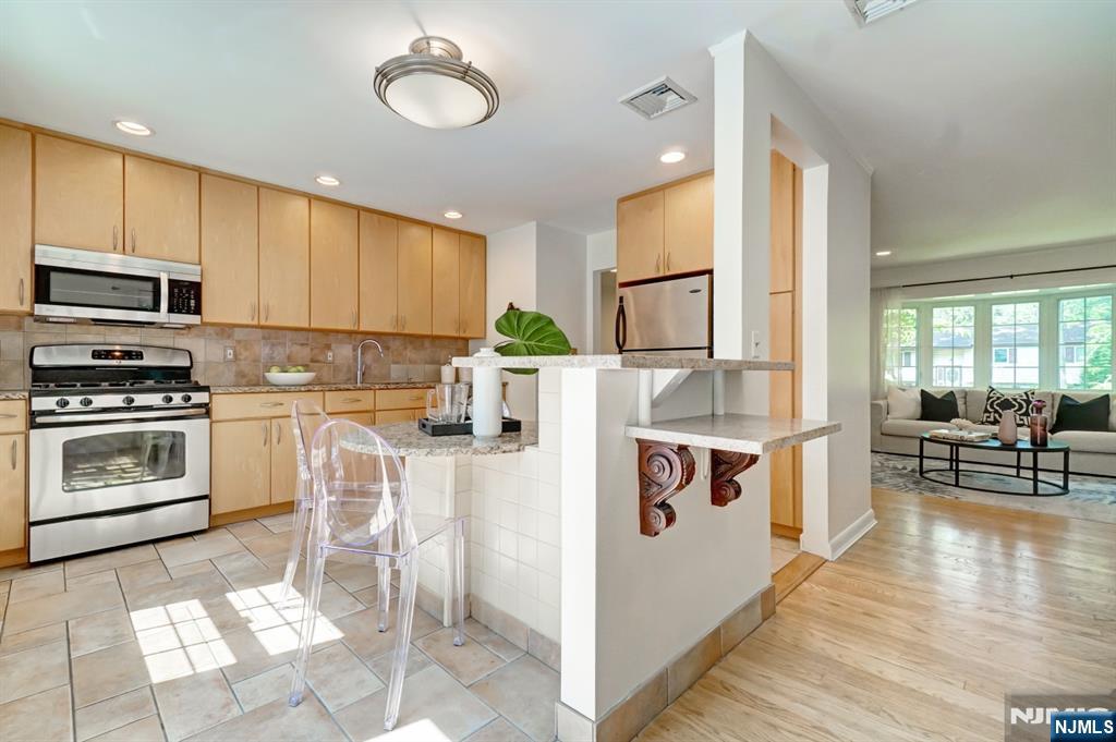 41 Demarest Avenue Demarest, NJ 07627 - Photo 8 of 28 a kitchen with a stove a sink and a refrigerator