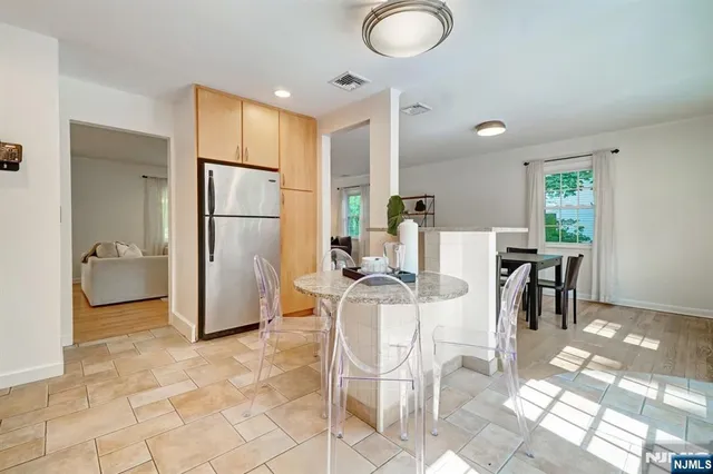 a kitchen with stainless steel appliances granite countertop a refrigerator and a stove top oven