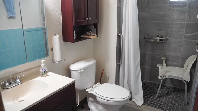 a white toilet sitting next to a bathroom sink and vanity