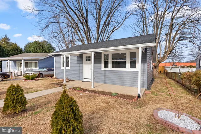 a front view of a house with a yard covered in snow