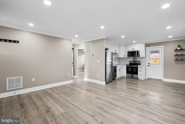 a view of kitchen with refrigerator microwave and wooden floor