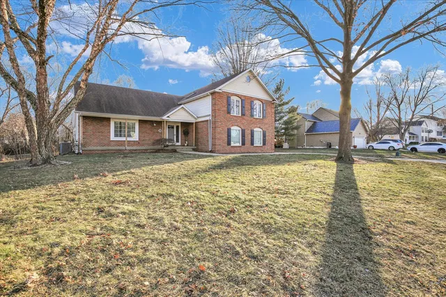 a large tree in front of a house