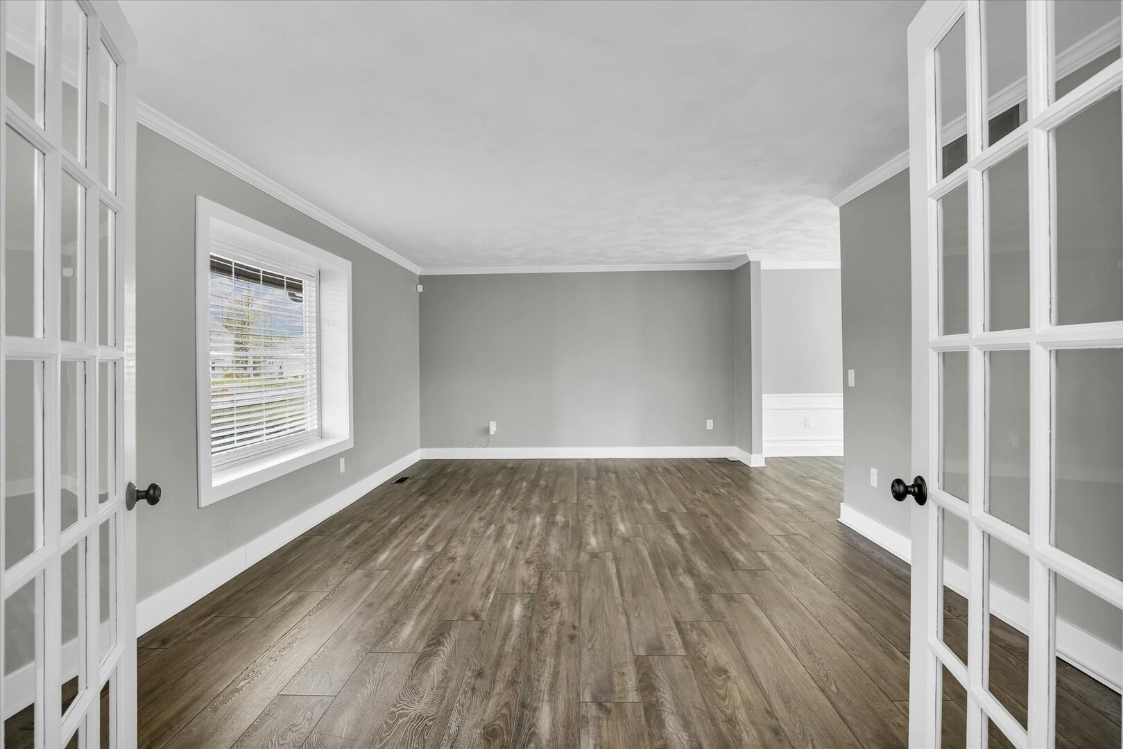 880 Stevens Creek Lane Forsyth, IL 62535 - Photo 11 of 56 a view of an empty room with wooden floor and a window