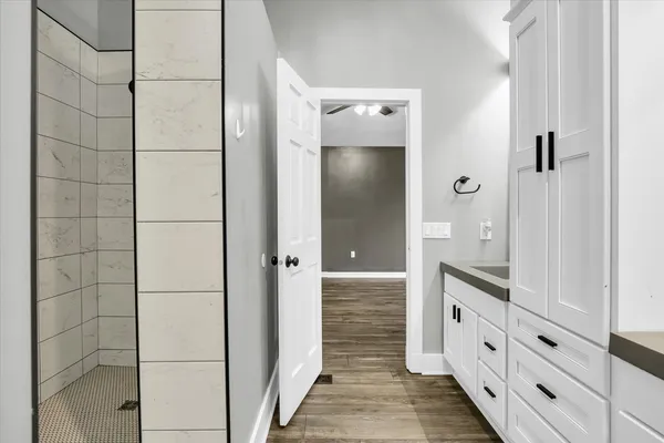 a view of a room with wooden floor and entryway