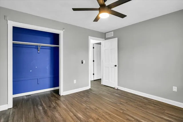 a bathroom with a granite countertop sink toilet and mirror