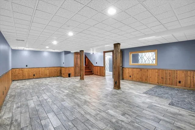 a view of house with deck and wooden floor