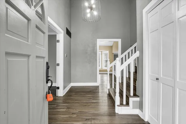 a view of an entryway with wooden floor and staircase