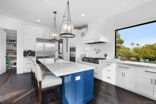 a kitchen with a table chairs and a clock