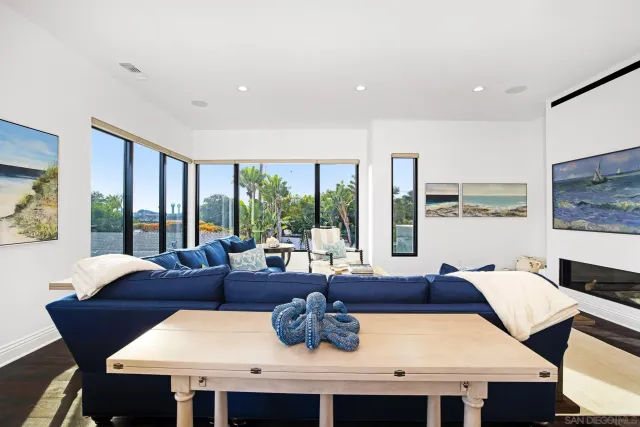 a dining room with furniture and a floor to ceiling window