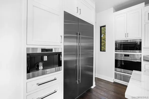 a dining room with furniture a chandelier and wooden floor