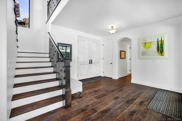 a view of a hallway with wooden floor and entryway