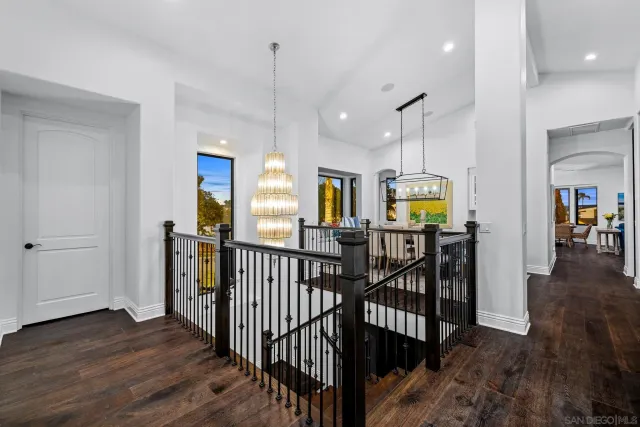 a dining room with furniture a chandelier and wooden floor