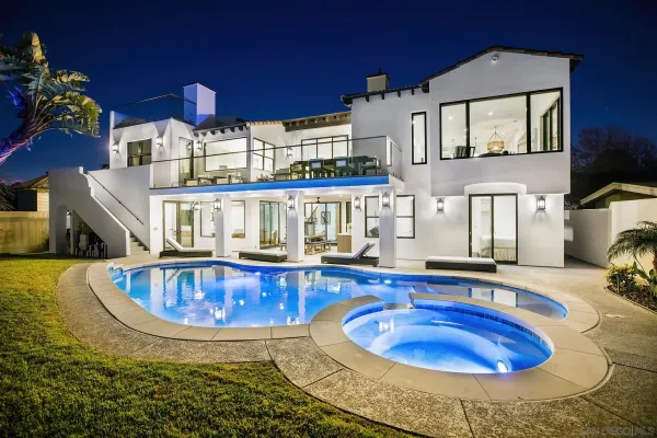 a view of a house with swimming pool and sitting area