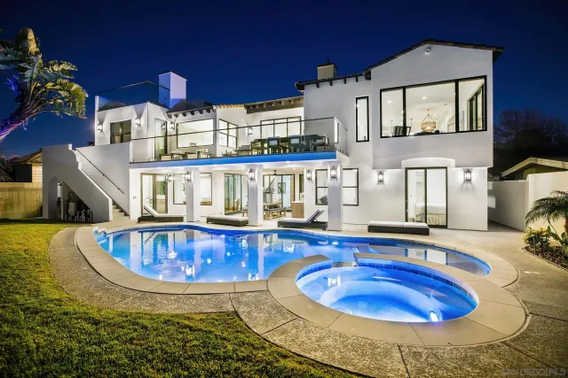 a view of a house with swimming pool and sitting area