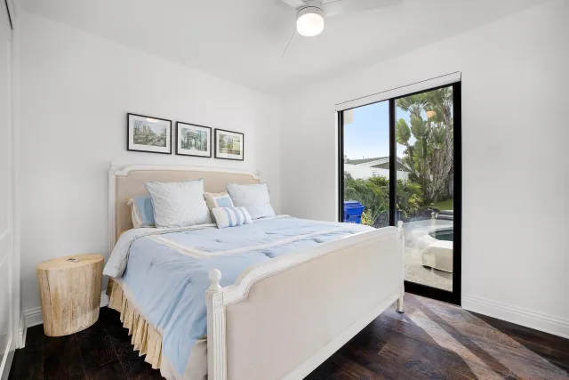 a spacious bathroom with a granite countertop sink a toilet mirror and bathtub