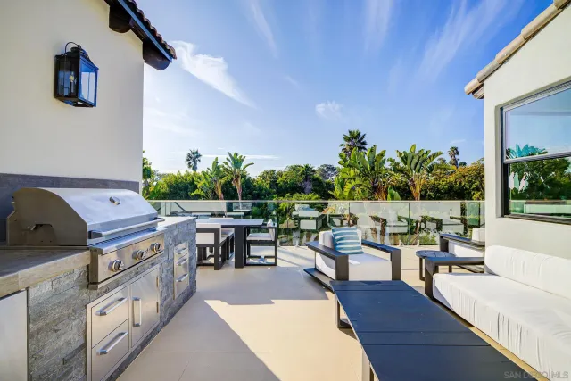 a view of a patio with couches table and chairs with potted plants