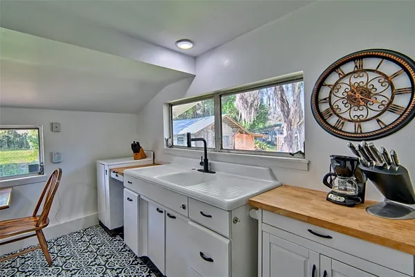 a kitchen that has a table and chair in it