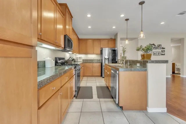 a kitchen with stainless steel appliances granite countertop lots of counter top space
