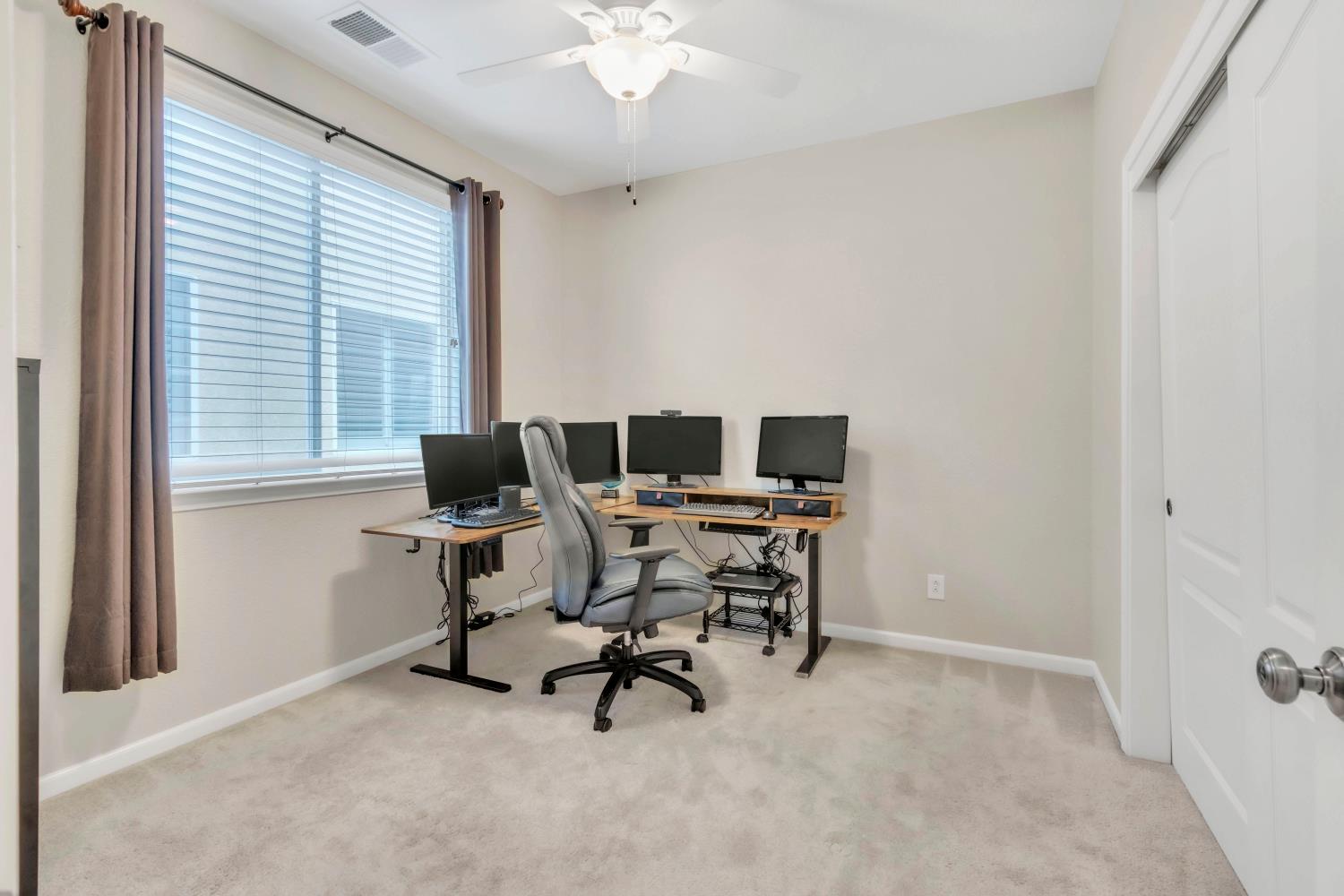 2993 Essie Place Modesto, CA 95355 - Photo 21 of 44 a view of a workspace with furniture and a window