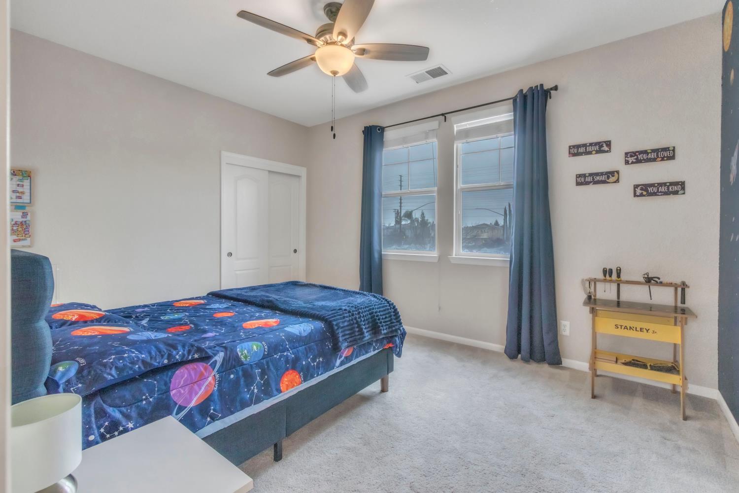 2993 Essie Place Modesto, CA 95355 - Photo 23 of 44 a bedroom with a bed and a chandelier